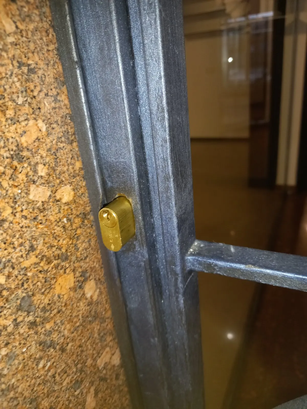 Cilindro europeo nuovo in ottone montato sul profilo di una porta in ferro